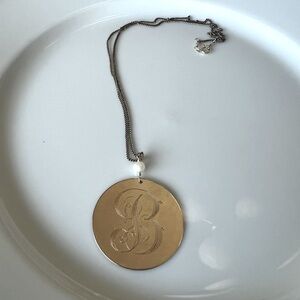 Gold necklace with letter “B”